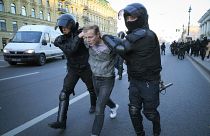 Russian policemen detain a demonstrator protesting against mobilization in St. Petersburg, Russia, Saturday, Sept. 24, 2022.
