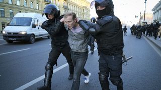 Russian policemen detain a demonstrator protesting against mobilization in St. Petersburg, Russia, Saturday, Sept. 24, 2022.