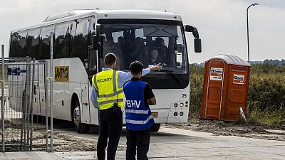 A bus transports asylum seekers from Ter Apel arriving at an emergency shelter, 10 September 2022
