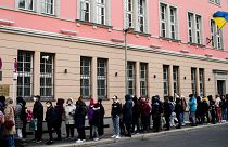 FILE --People from Ukraine, most of them refugees fleeing the war, wait in front of the consular department of the Ukrainian embassy in Berlin, Germany, on April 1, 2022.