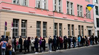 FILE --People from Ukraine, most of them refugees fleeing the war, wait in front of the consular department of the Ukrainian embassy in Berlin, Germany, on April 1, 2022.