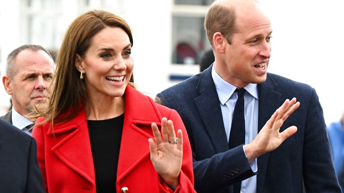 Britain's Kate, Princess of Wales, and Prince William wave during their visit to the RNLI Holyhead Lifeboat Station in Anglesey, north Wales, 