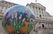 A globe sits beside the Bank of England in London, Tuesday, Sept. 27, 2022