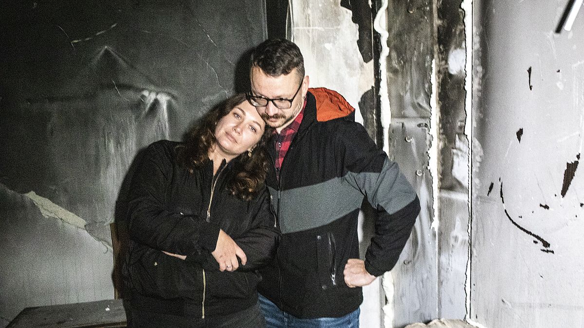 Anastasia and Roman Akulenko stand in their flat covered with ash. Irpin, Kyiv suburb, Ukraine. September 27, 2022