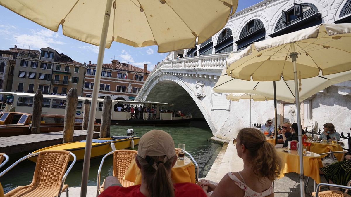 Customers sit at a cafe, in Venice, Italy, Thursday, 17 June 17 2021.