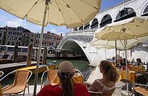 Customers sit at a cafe, in Venice, Italy, Thursday, 17 June 17 2021.
