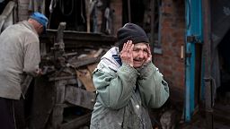 Valentina Bondarenko reacts as she stands with her husband Leonid outside their house that was heavily damaged after a Russian attack in Sloviansk, Ukraine, 27 Sept, 2022