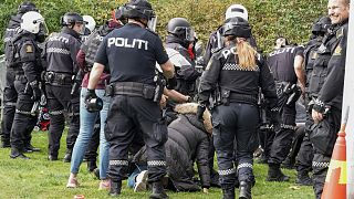 Police scuffle with demonstrators outside Iran's embassy in Oslo.