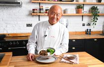 Ken Hom posing with a dish