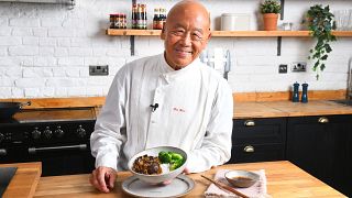 Ken Hom posing with a dish