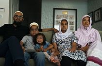 The Zakir family, from left, father Yusuf, son Burhanuddin, Yusuf's niece, Insiya Maimoon; daughter Jumana, mother Fareeda, watch "Ms. Marvel" in Anaheim, Calif., July, 2022.
