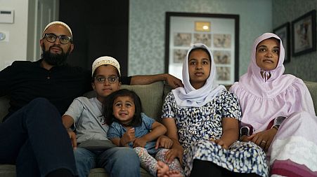 The Zakir family, from left, father Yusuf, son Burhanuddin, Yusuf's niece, Insiya Maimoon; daughter Jumana, mother Fareeda, watch "Ms. Marvel" in Anaheim, Calif., July, 2022.
