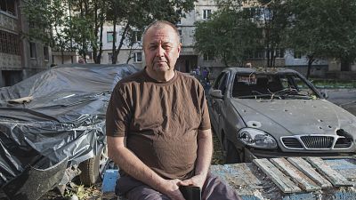 Volodymyr sits amid the aftermath of the explosions near his flat in Mykolaiv, Ukraine. October 1, 2022