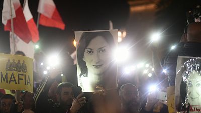 Protestors hold up a pictures of slain journalist Daphne Caruana Galizia during a demonstration outside Malta's prime minister's office in Valletta, Malta, 2019