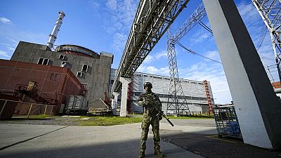 Russian soldier stands guard at the Zaporizhzhia nuclear power plant