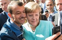 In this Sept. 9, 2015 file photo German chancellor Angela Merkel poses for a selfie with a refugee in a facility for arriving refugees in Berlin.