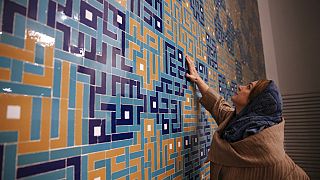  كاترين سبيريدونوف، مهندسة معمارية مشتركة لمسجد ولي العصر تلامس البلاط الملون الذي يزين محراب المسجد، في طهران، إيران، في 7 فبراير 2018