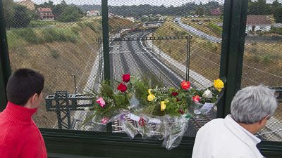 Flowers are placed on a bridge above the railway line at the spot of the train crash.