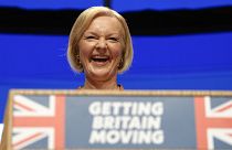 Britain's Prime Minister Liz Truss laughs during her speech at the Conservative Party conference