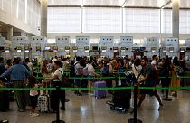Vueling passengers queue at check-in desks at Malaga-Costa del Sol Airport in Malaga, Spain.