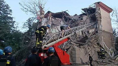 In this photo provided by the Ukrainian Emergency Service, rescuers work at the scene of a building damaged by shelling in Zaporizhzhia, Ukraine, Thursday, Oct. 6, 2022.