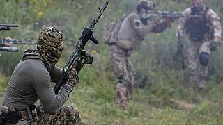 Volunteer soldiers attend a training outside Kyiv, Ukraine, Saturday, Aug. 27, 2022.