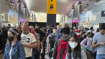 Travellers queue at security at Heathrow Airport in London in June.