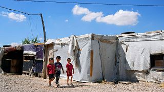 Syrian children walk past their family tents at a refugee camp in the town of Bar Elias, in Lebanon's Bekaa Valley, Tuesday, June 13, 2023.
