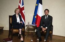UK Prime Minister Liz Truss and French President Emmanuel Macron meet on the sidelines of the European Political Community meeting in Prague, Czech Republic, Oct 6, 2022. 