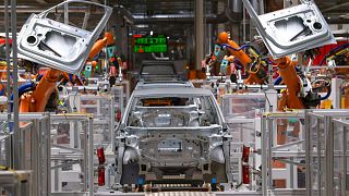  تعمل الروبوتات على هيكل سيارة كهربائية في خط التجميع في مصنع الشركة الألمانية Volkswagen AG (VW) تسفيكاو، ألمانيا، فبراير 2020.