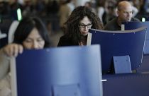 Travellers going through passport control at John F. Kennedy Airport