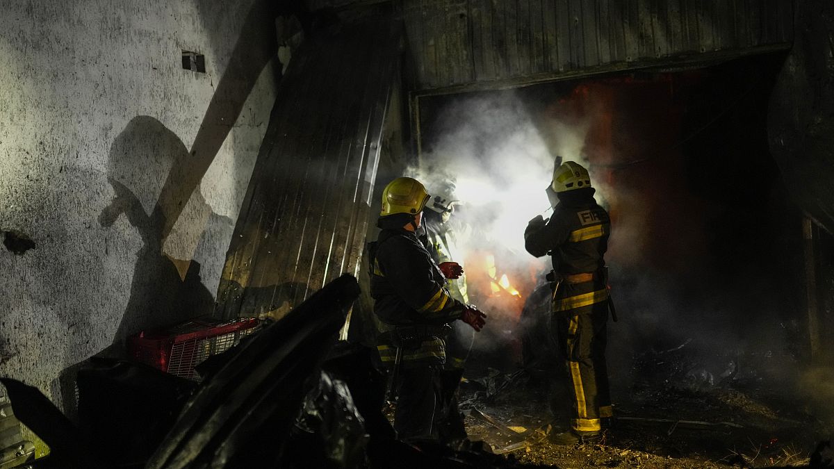 Украинские пожарные работают на месте взрыва в Харькове утром 8 октября
