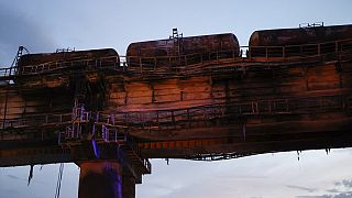 A view of burnt tanks on a damaged part of the Crimean Bridge over the Kerch Strait, near Kerch, Crimea, Saturday, Oct. 8, 2022.