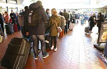 Travelers stand in long lines at the travel center in Hamburg Central Station after long-distance services in northern Germany came to a standstill, Hamburg, Germany, 8, Oct.