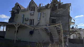 A damaged building is seen on a street in the recaptured town of Lyman