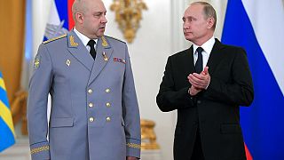 Russian President Vladimir Putin applauds Sergei Surovikin during an awards ceremony for troops who fought in Syria