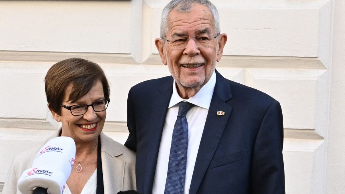 Austria's President Alexander Van der Bellen and his wife Doris speak to the media in front of a polling station in Vienna, in presidential elections on October 9, 2022.
