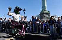 A young girl practices freestyle wheelchair acrobatics during the first edition of the Paralympic Day on the Place de la Bastille in Paris on October 8, 2022