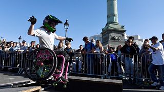 A young girl practices freestyle wheelchair acrobatics during the first edition of the Paralympic Day on the Place de la Bastille in Paris on October 8, 2022