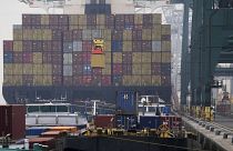 A container is loaded onto a ship in the Port of Antwerp on Wednesday, Aug. 17, 2022.