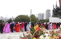 Citizens pay tribute before the statues of North Korea leaders Kim Il Sung and Kim Jong Il