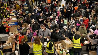 Ukrainian refugees queue for food in the welcome area after their arrival at the main train station in Berlin, Germany, March 8, 2022.