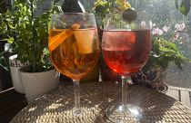 Spritz cocktails served with a slice of orange and an olive