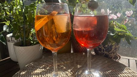 Spritz cocktails served with a slice of orange and an olive