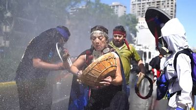 Indigenous protesters play music.