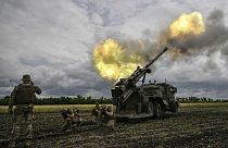Ukrainian servicemen fire with a French self-propelled 155 mm/52-calibre gun Caesar towards Russian positions in the eastern Ukrainian Donbas region, June 15, 2022.