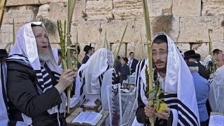 Worshippers pray by Western Wall during Sukkot