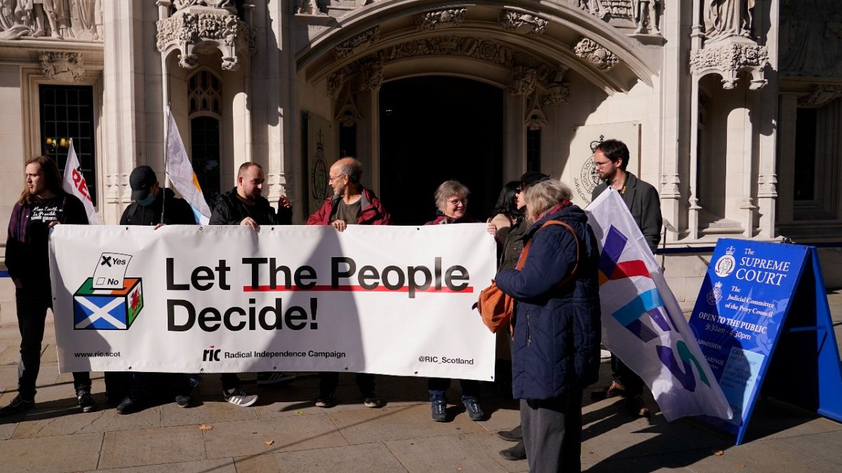 Supporters of Scottish Independence hold a banner outside the Supreme Court in London, Tuesday, Oct. 11, 2022.