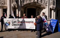 Supporters of Scottish Independence hold a banner outside the Supreme Court in London, Tuesday, Oct. 11, 2022.