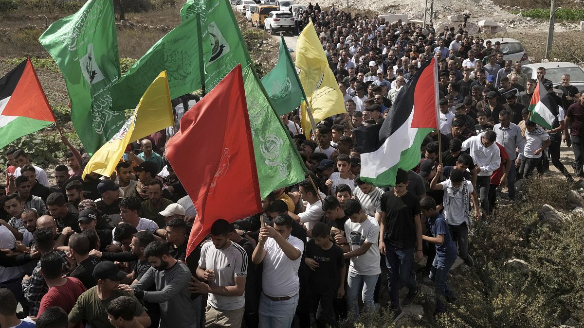 فلسطينيون يشيّعون جثمان الشاب أسامة عدوي الذي قُتل برصاص جنود الاحتلال الإسرائيلي في مخيم العروب للاجئين الفلسطينيين بالضفة الغربية المحتلة، 13 أكتوبر 2022.